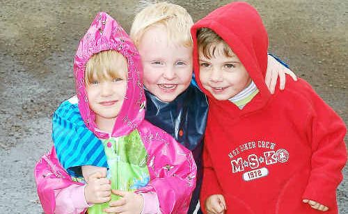 Four-year-old twins Ashleigh and Lachlann Locke with friend Jack Perkins, 3, had fun donning their raincoats yesterday. Four-year-old twins Ashleigh and Lachlann Locke with friend Jack Perkins, 3, had fun donning their raincoats yesterday.